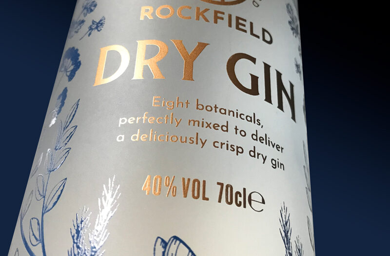 Close up of Rockfield Distillery's dry gin bottle screen printed copper and blue